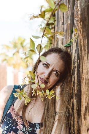 Adult woman behind tree twig