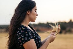 Portrait of a young woman with long hair in the countrysid