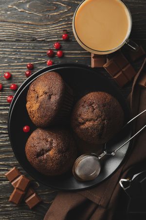 Composition with tasty muffins and cocoa drink on wooden background