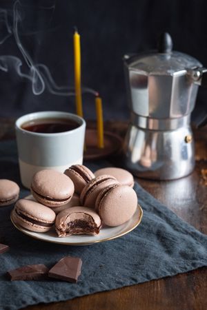 Chocolate flavored macarons served with hot coffee