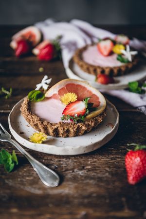 Strawberry and citrus cake served on wooden table