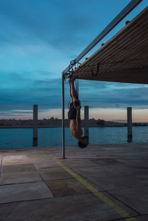 Athletic man balancing on gymnastic rings