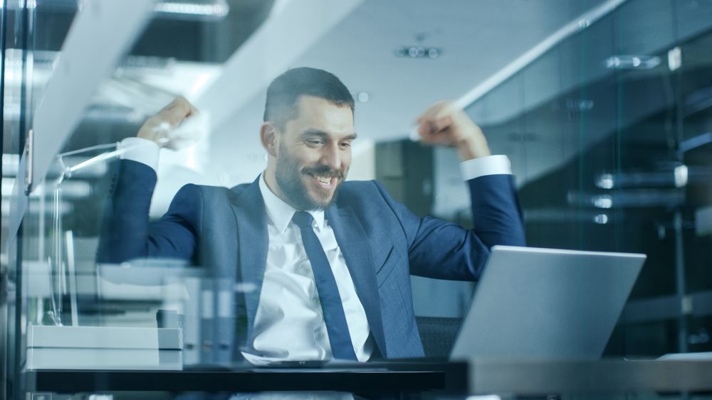 Businessman Works on a Laptop at His Desk