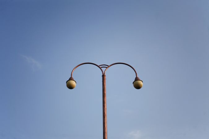 Street lamp against clear blue sky
