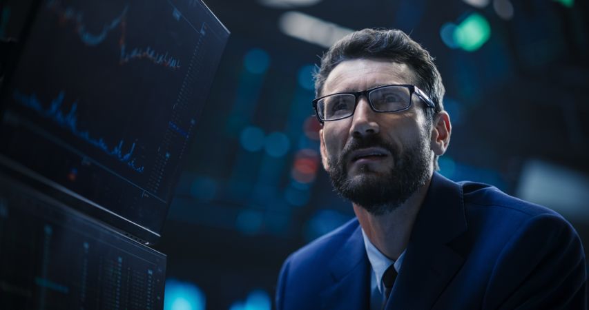 Portrait of a Bearded Stock Market Trader Working in a Stock Exchange Company.