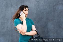 Transgender businesswoman taking a call outside 0LKkXb