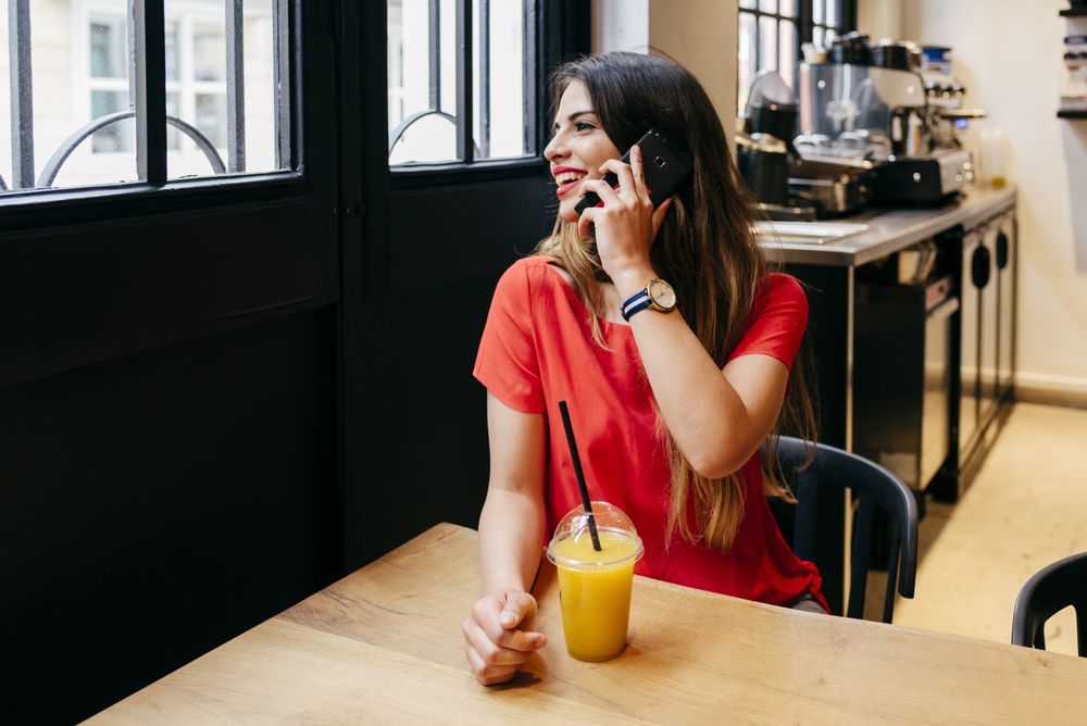 Woman taking call in cafe