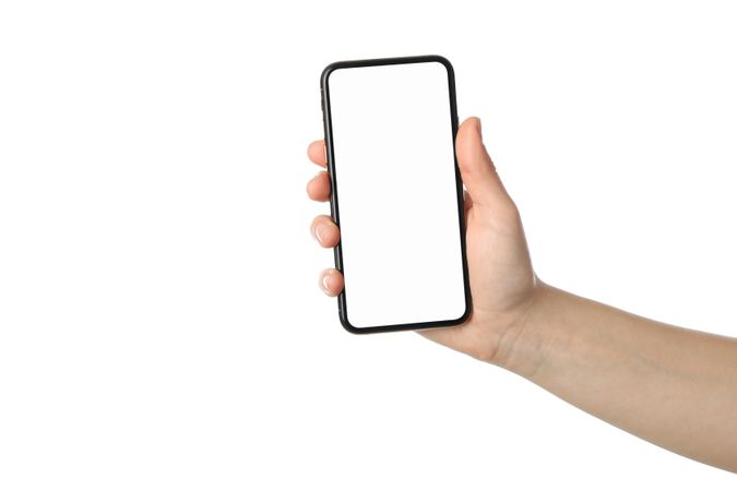 Female hand holding phone with empty screen, isolated on plain background