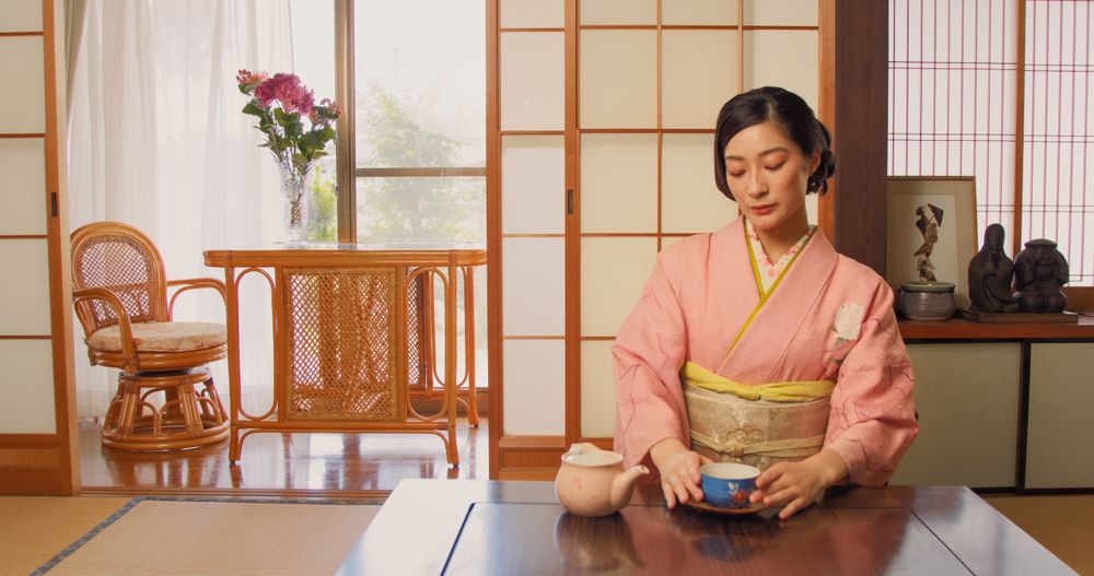 Young Japanese Female Enjoying Time Alone and Drinking Tea at Home.
