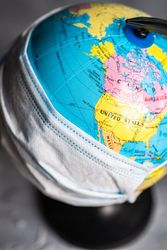 Round globe covered in facemask