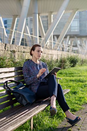 Businesswoman browsing tablet in park