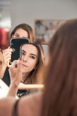Charming model looking at mirror