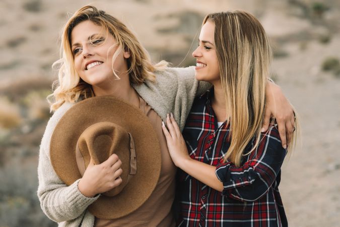 Content blond women cuddling on nature