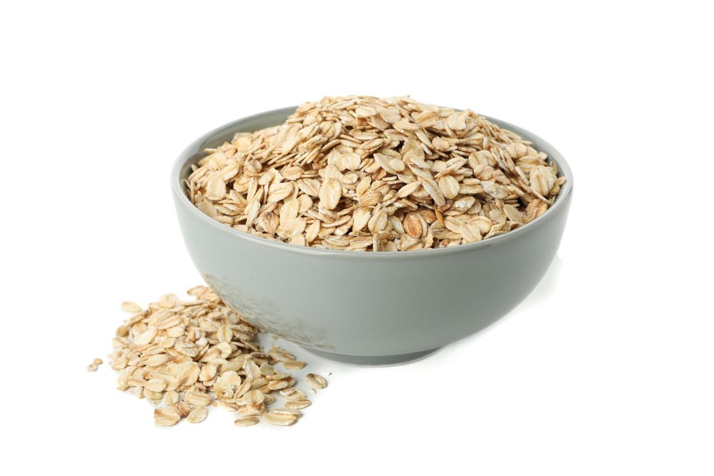 Bowl with oatmeal flakes isolated on plain background
