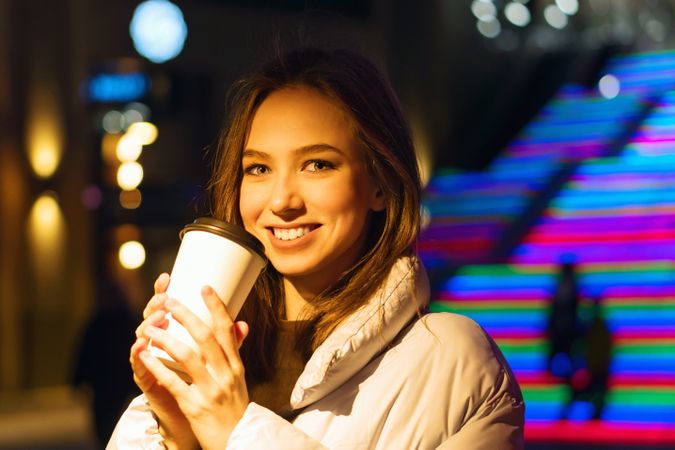 Smiling woman enjoying nightlife in city