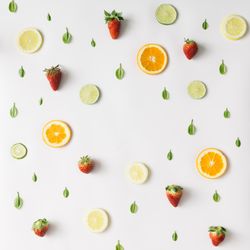 Colorful pattern made of citrus fruits, leaves and strawberries