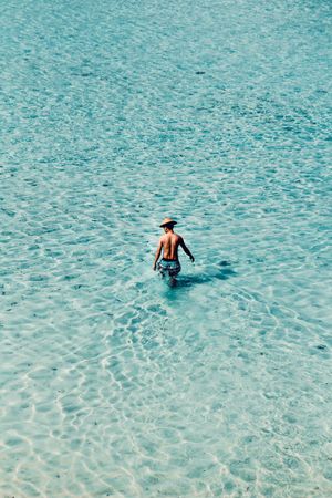 Man standing on shallow water in the sea