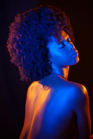 Female with closed eyes in blue studio shot