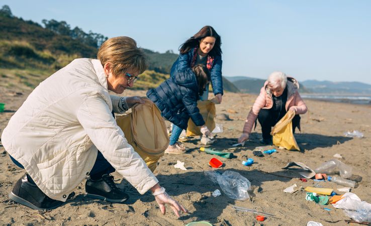 Female volunteers cleaning the beach