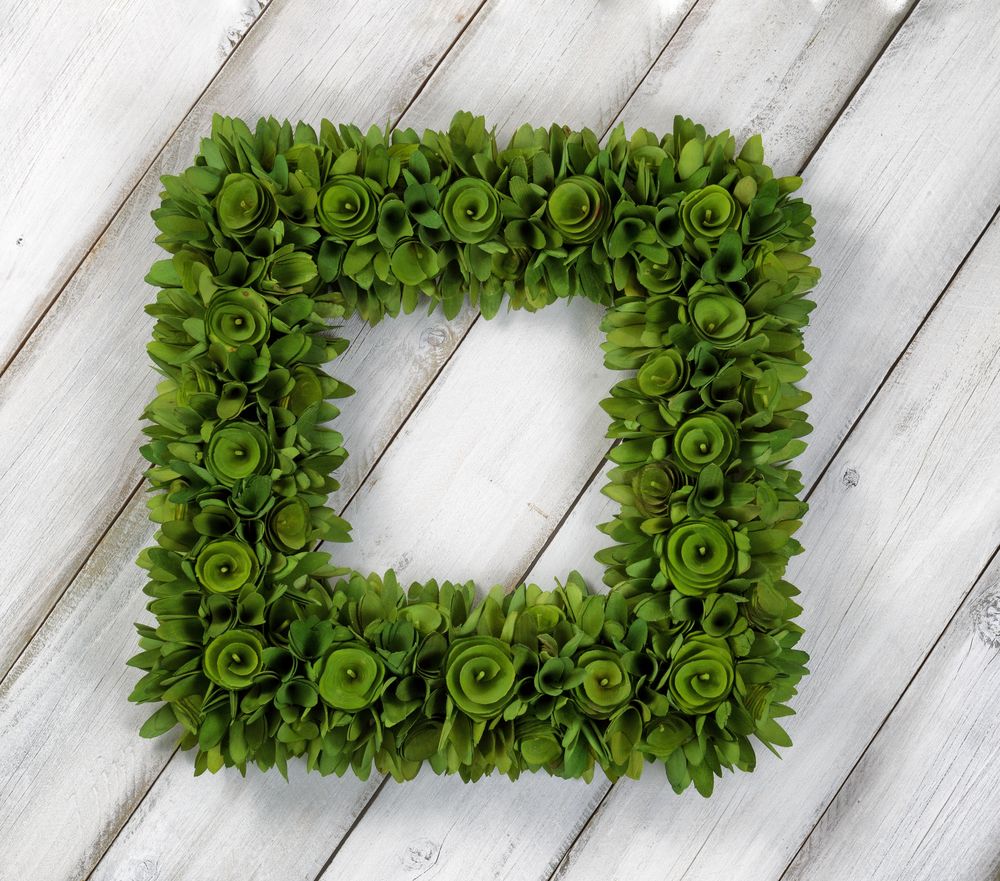 Wreath made with wood chips on rustic wooden boards