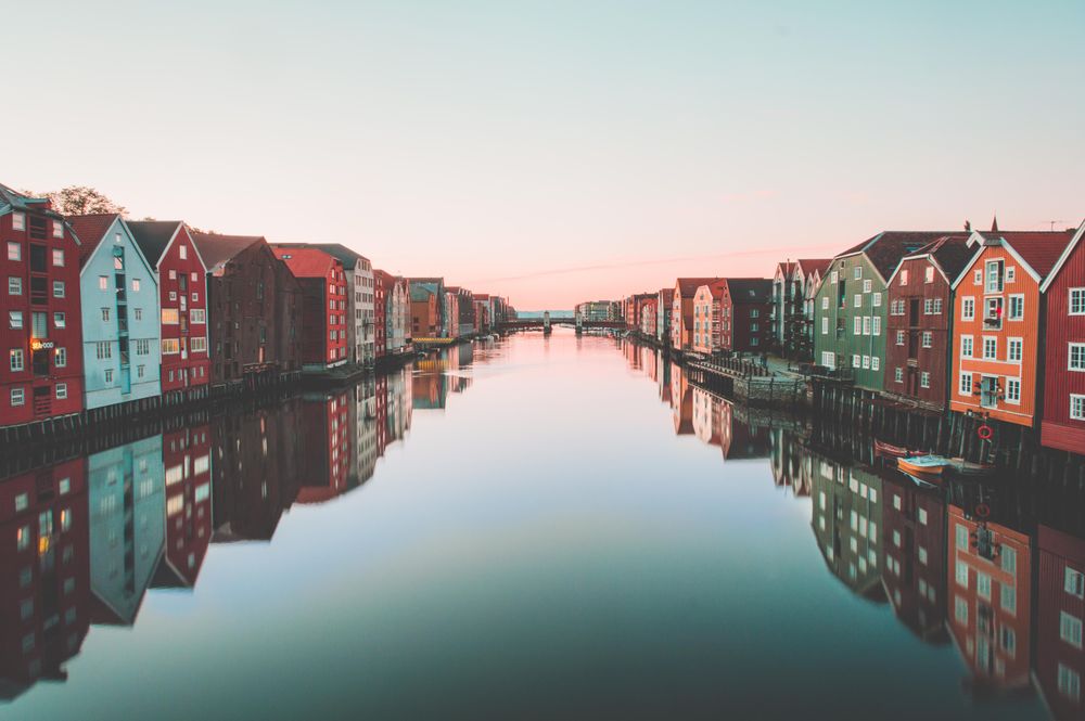 Line of colorful buildings near water in old town bridge Trondheim