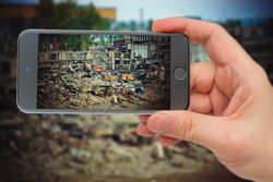 Person taking photo of crane and excavator