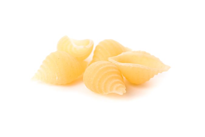 Pasta isolated on studio background, closeup. Dry raw whole pasta