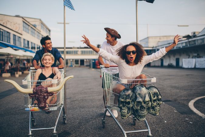 Young friends having fun on a shopping cart