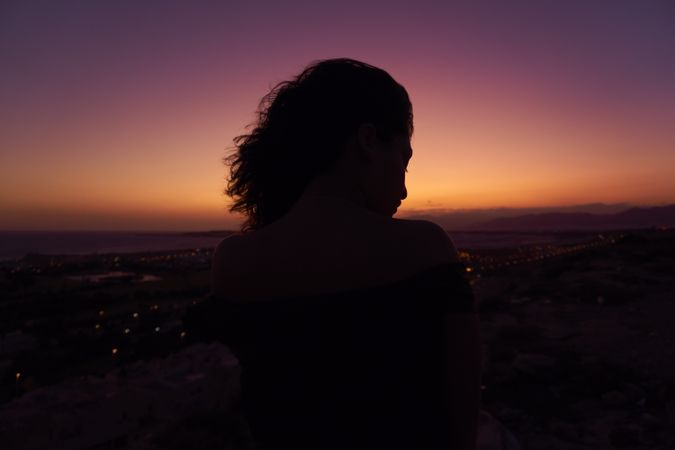 Silhouette of female enjoying picturesque sunset