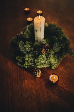 Advent wreath with burning candles on table