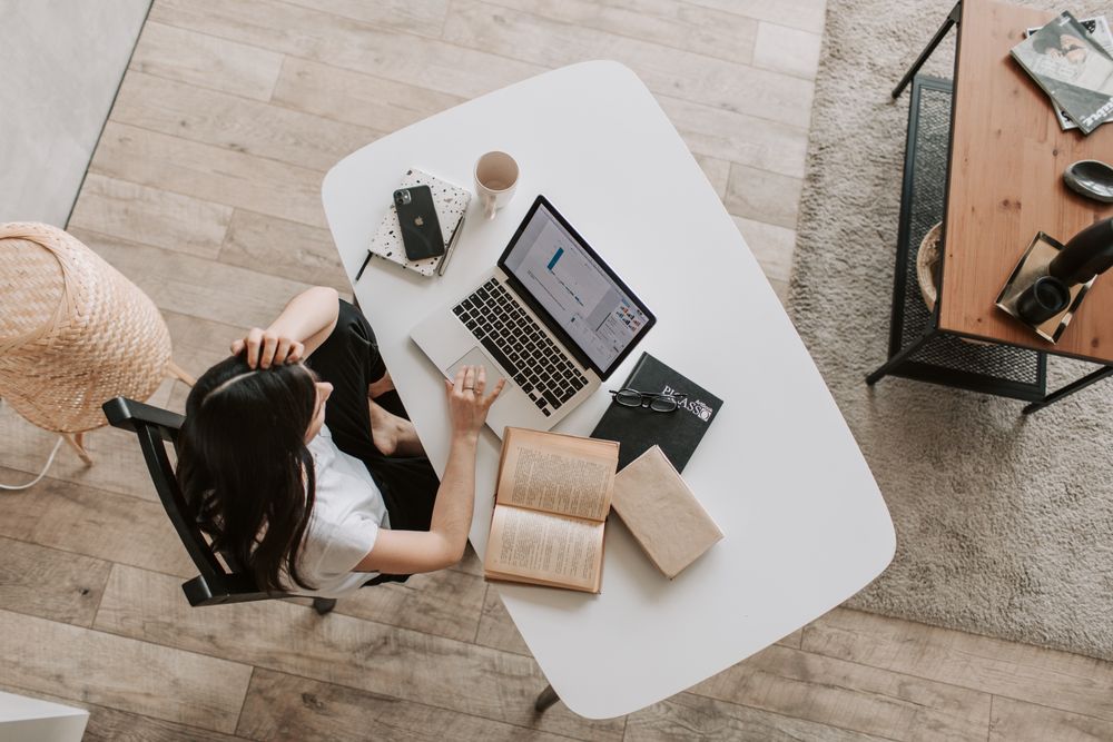 Top view of young woman working on computer in an office