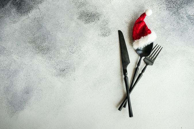 Christmas table setting with Santa hat on cutlery