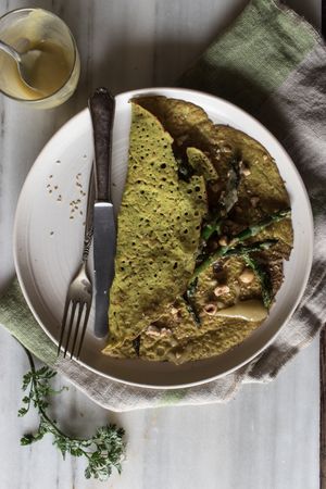 Served vegetarian crepe with oats and asparagus