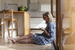 Woman at home leaning in a windows