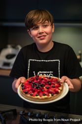 Boy holding strawberry tart 5oxYy4