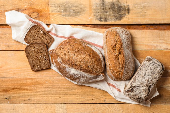 Flat lay composition with bakery products on wooden background, top view and space for text
