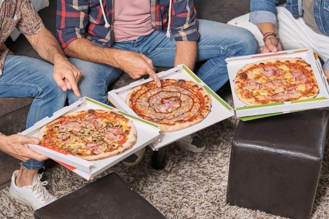 Crop friends with assorted pizza at home