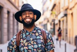 Stylish Black man walking on the city street