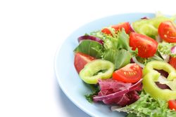 Salad of fresh vegetables isolated on plain background, close up