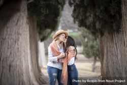 Mother and daughter hugging nears trees 4Z37Ob
