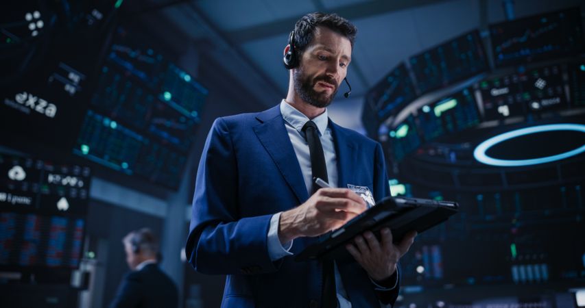 Proactive Trader Communicating Orders with a Headset and Microphone, Talking on a Call with Auction Operators