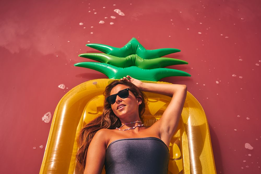 Dreamy female resting on inflatable mattress