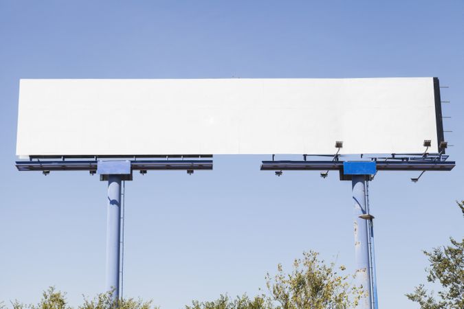 Big blank advertising board against blue background