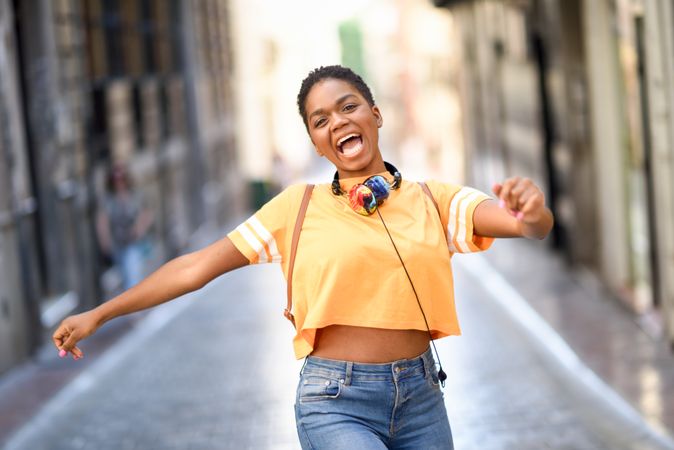 Female happily dancing in street
