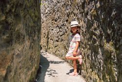 Girl in narrow stone walkway