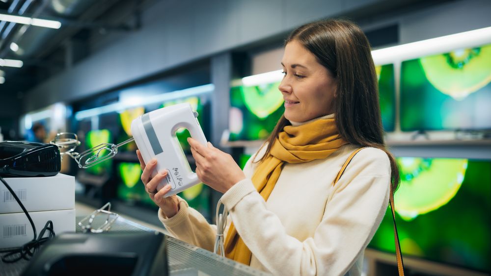 Female Client Shopping for a New Kitchen Appliance in a Home Electronics Store