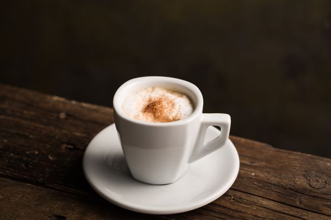 Cups of tasty hot coffee drink on wooden table