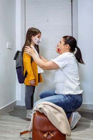 Mother advising daughter about coronavirus precautions