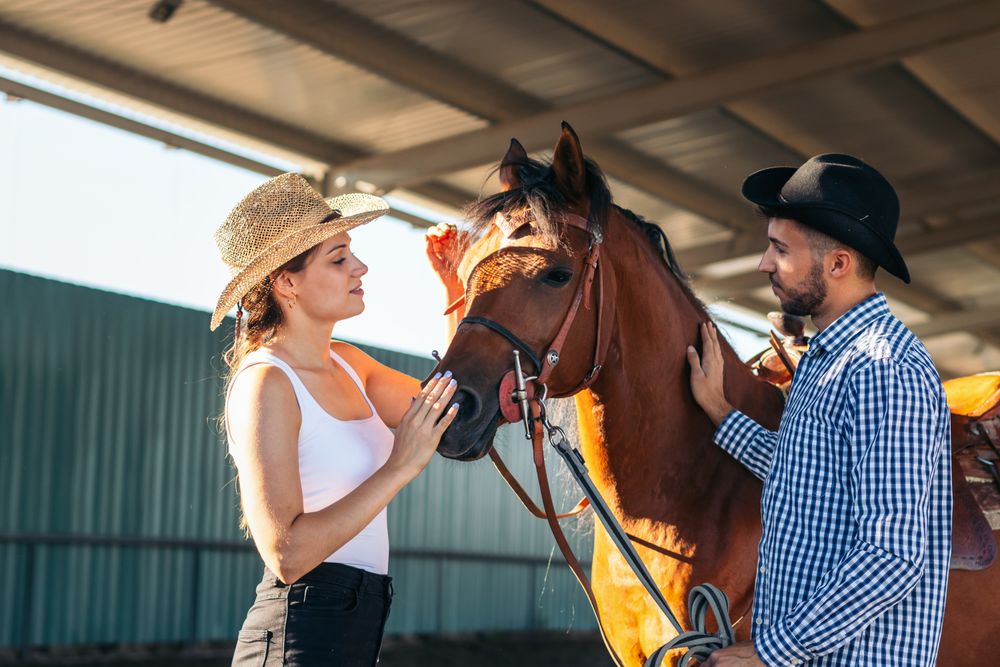 Friends walking with a horse in an equestrian center