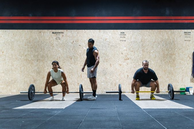 Hispanic sportspeople training with barbells